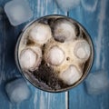 Cola in glass with ice from top.