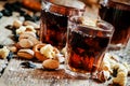 Cola glasses, sweet and savory snacks, old wooden table, unhealt