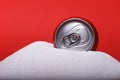 Cola refreshing drink can sitting in pure white sugar mountain