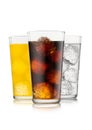 Cola soda drink with lemonade and orange soda with ice cubes and bubbles on white Royalty Free Stock Photo