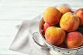 Colander with delicious ripe peaches