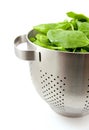 Colander filled with fresh spinach