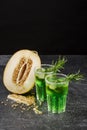 Cold alcohol cocktails. Two glasses of green drinks with tarragon and lime. A cut lemon and sour lime. Alcoholic summer drinks. Royalty Free Stock Photo