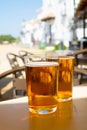 Cold amber color light spanish beer served in glass in outdoor cafe in town on sand, El Rocio in Andalusia, Spain Royalty Free Stock Photo