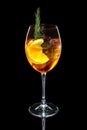 Cold Apple and orange cocktail with a sparkling wine with ice in wine glass isolated on black Royalty Free Stock Photo