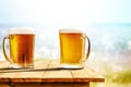 Cold beer in big glass on wooden table with ocean and sandy beach background. Copy space for advertising product. Royalty Free Stock Photo