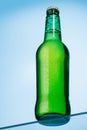 A cold beer bottle standing on a glass table Royalty Free Stock Photo
