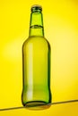 A cold beer bottle standing on a glass table Royalty Free Stock Photo
