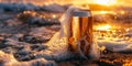 Cold beer can covered by sea foam at sunset on the beach Royalty Free Stock Photo