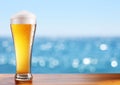 Cold beer glass on the bar table at the open-air cafe. Royalty Free Stock Photo