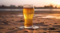 cold beer glass in the sand. Sparkling sea at the background. Generative Ai Royalty Free Stock Photo