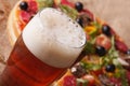 Cold beer macro on a background of pizza on the table Royalty Free Stock Photo