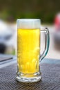 Cold beer mug with foam isolated on a table Royalty Free Stock Photo