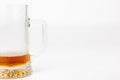 Cold Beer Mug, Partially Empty with Dark Ale, White Backdrop Royalty Free Stock Photo