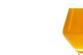 Cold beer in a Teku tasting glass filled to full with foam, drops of water on glass, half glass visible on the right, isolated on Royalty Free Stock Photo