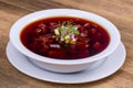 Cold beetroot soup. Summer light cold vegetable soup with beetroot on a wooden table. A traditional dish of russian or ukrainian c