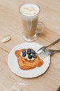 Cold black coffee with ice cubes in tall glass and fresh croissant. Royalty Free Stock Photo