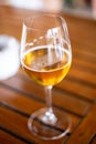 Cold blond beer served on a wineglass close up still  on a wooden table Royalty Free Stock Photo