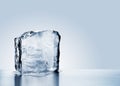 Melting cold blue ice block with reflection Royalty Free Stock Photo