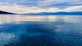 Cold Blue Light, Overcast Early Morning Reflections on Sea, Greece Royalty Free Stock Photo