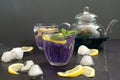 Cold blue Thai Anchan tea in a glass cup with ice and lemon on a black background. Copy space Royalty Free Stock Photo