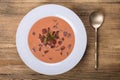 Cold borscht - beetroot soup. Summer light cold vegetable soup with beet, cucumber, radsih, potato, egg and kefir on a wooden tabl