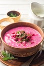 Cold borscht or Holodnik, traditional summer beet soup in ceramic bowl on wooden background Royalty Free Stock Photo