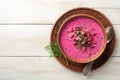 Cold borscht or Holodnik, traditional summer beet soup in ceramic bowl on wooden background Royalty Free Stock Photo
