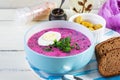 Cold borscht on white wooden background. Cold beet soup