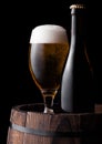 Cold bottle and glass of craft beer on old barrel Royalty Free Stock Photo