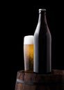 Cold bottle and glass of craft beer on old barrel Royalty Free Stock Photo