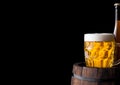 Cold bottle and glass of craft beer on old barrel Royalty Free Stock Photo