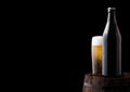 Cold bottle and glass of craft beer on old barrel Royalty Free Stock Photo