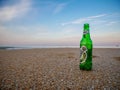 A cold bottle of Tuborg in the sand on a hot, summer's day. Royalty Free Stock Photo