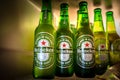 Marinette,WI / U.S.A. - Aug16,2019: Cold bottles of Heineken Beer with drops over green background. Heineken is the flagship produ Royalty Free Stock Photo