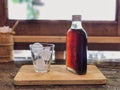 Cold brew coffee bottle and ice on glass on wooden tray and wooden Royalty Free Stock Photo