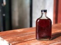 Cold brew coffee bottle  on the wooden with natural  light. Royalty Free Stock Photo