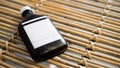 Cold brew coffee bottle on woven wooden table. Royalty Free Stock Photo