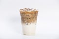 Cold brewed iced latte coffee, the bottom as milk top by coffee shot in a plastic glass 16oz. isolated white background