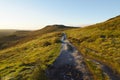 Cold, bright autumn morning on the frosty path to Higger Tor