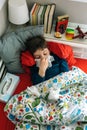 Cold child lying on the bed Royalty Free Stock Photo