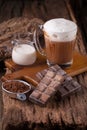 Cold Chocolate Milk drink and chocolate bar on wooden background Royalty Free Stock Photo