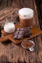 Cold Chocolate Milk drink and chocolate bar on wooden background Royalty Free Stock Photo