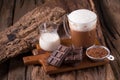 Cold Chocolate Milk drink and chocolate bar on wooden background Royalty Free Stock Photo