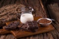 Cold Chocolate Milk drink and chocolate bar on wooden background Royalty Free Stock Photo