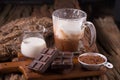 Cold Chocolate Milk drink and chocolate bar on wooden background Royalty Free Stock Photo