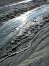 Cold clayey mud mixed with hydrocarbons, flows down from a mud volcano in the natural reserve of Salse of Nirano.