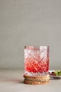 Cold Clear Drink of Red Berries with Ice, Water, Sugar in a Crystal Glass on Wooden Plate Royalty Free Stock Photo