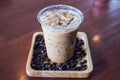 Cold coffee drink frappe or frappuccino in wooden tray with coffee bean