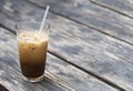 Cold coffee with milk in a glass beaker.